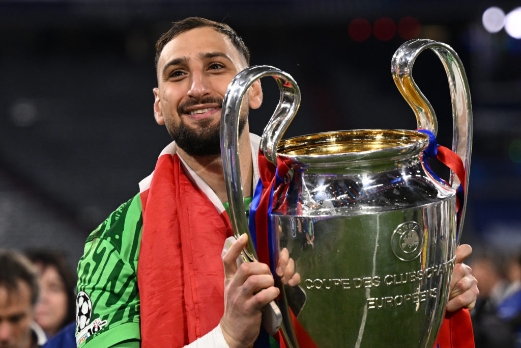 Gianluigi Donnarumma poses with the Champions League trophy.