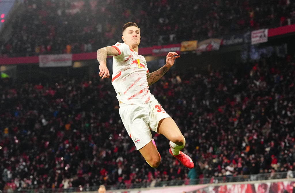 Benjamin Sesko leaps into the air to celebrate for Leipzig.