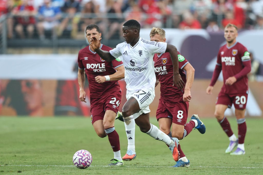 Kobbie Mainoo of Manchester United runs with the ball against West Ham.