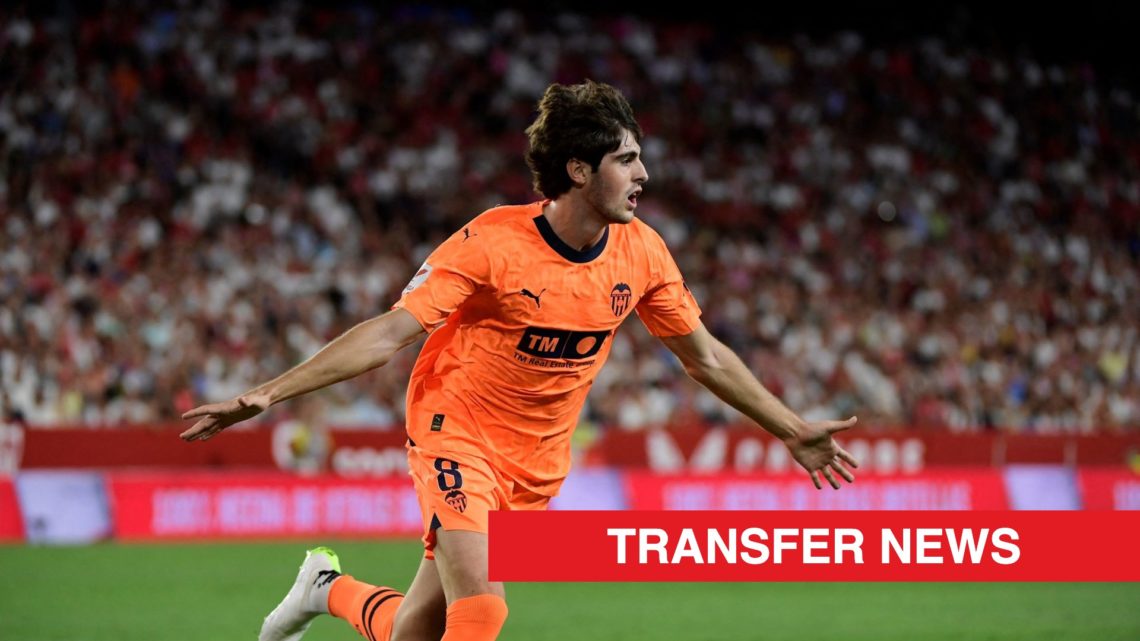 Valencia midfielder Javi Guerra celebrates scoring against Sevilla, with a red transfer news banner.