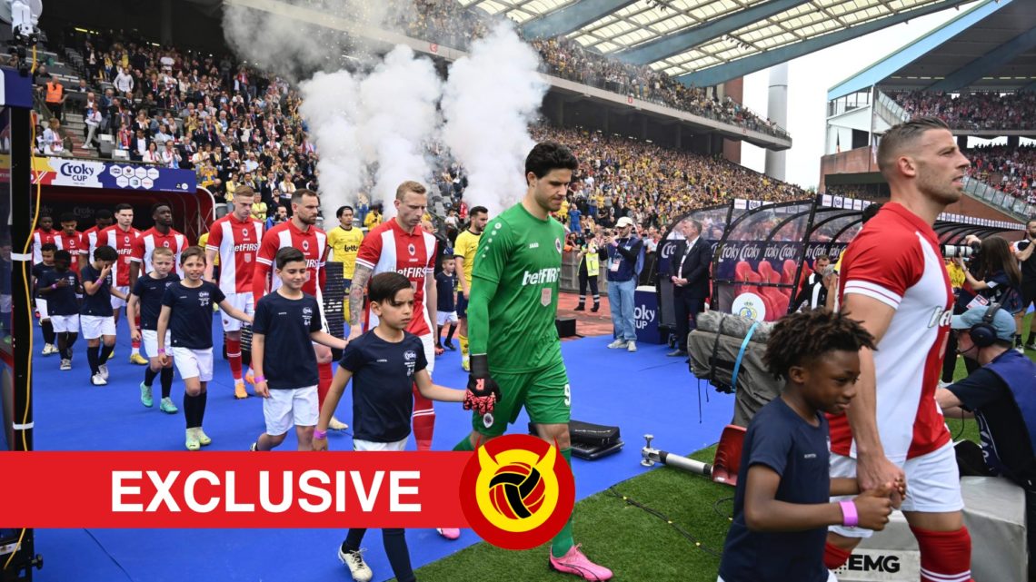 Senne Lammens walking out of the tunnel for Antwerp with smoke behind him. Overlaid UIF logo and exclusives banner.