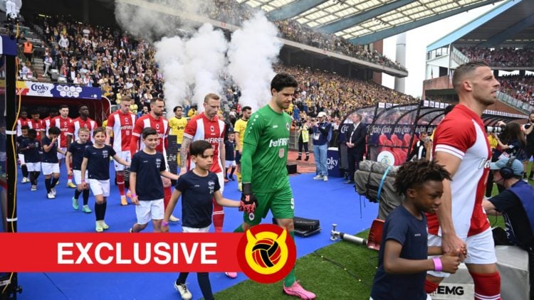 Senne Lammens walking out of the tunnel for Antwerp with smoke behind him. Overlaid UIF logo and exclusives banner.