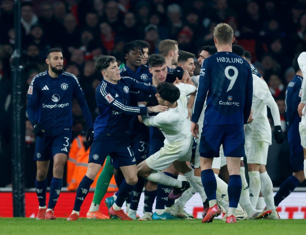 Manchester United and Arsenal players clash, with Kai Havertz being pushed to the floor