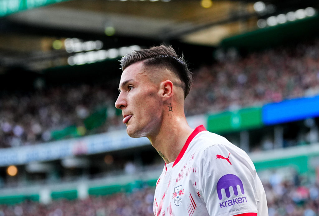 Benjamin Sesko looks on during the Bundesliga match, pictured from side.