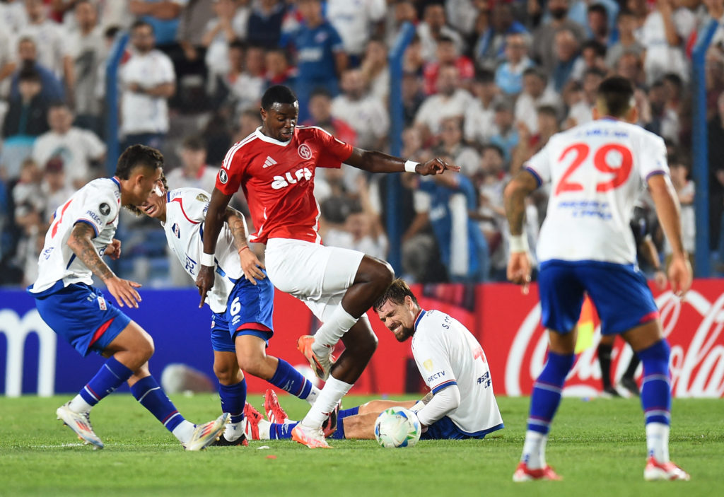 Nacional's midfielder #08 Christian Oliva, Nacional's midfielder #06 Luciano Boggio and Internacional's forward #49 Ricardo Mathias fight for the ball