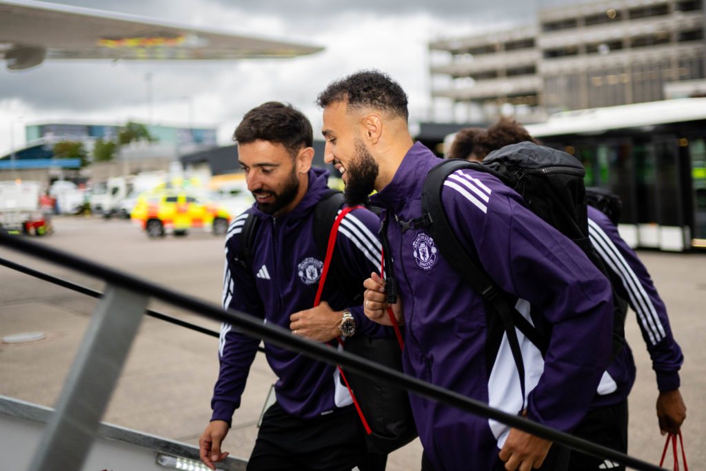 Bruno Fernandes and Noussair Mazraoui chat as they board plane
