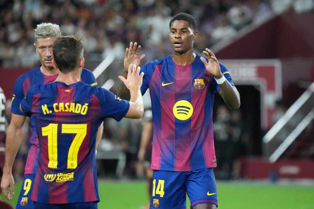 Marcus Rashford high fives Barcelona teammate Casado