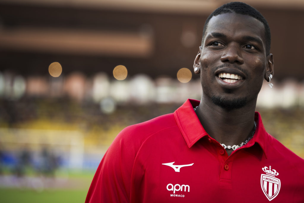 Paul Pogba smiles in a Monaco shirt