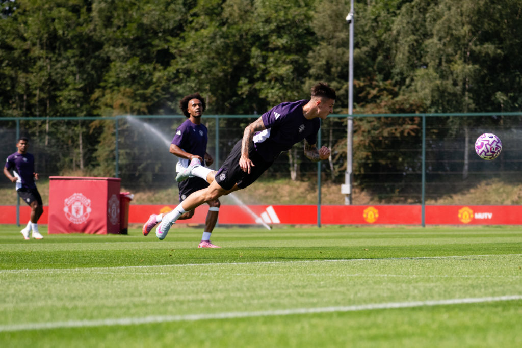 Benjamin Sesko goes for a diving header in training at Carrington.
