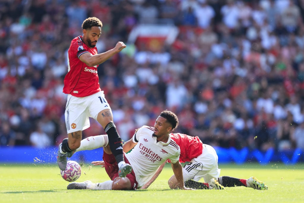 William Saliba battles with Matheus Cunha during the Premier League match between Manchester United and Arsenal at Old Trafford in 2025 in Manchester, England.