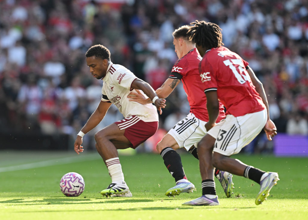 Jurrien Timber of Arsenal is challenged by Manuel Ugarte and Patrick Dorgu of Manchester United