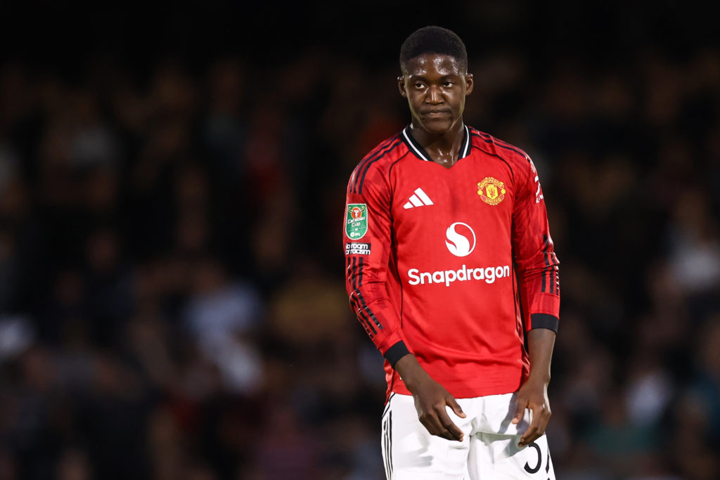 Kobbie Mainoo of Manchester United standing looking annoyed vs Grimsby.
