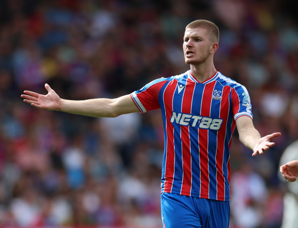 Crystal Palace midfielder Adam Wharton, with both arms out.
