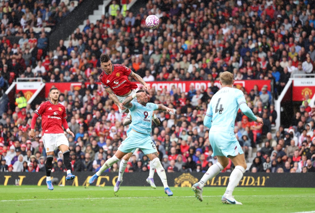 Benjamin Sesko of Manchester United shoots under pressure from Kyle Walker of Burnley during the Premier League match between Manchester United and Burnley at Old Trafford on August 30, 2025