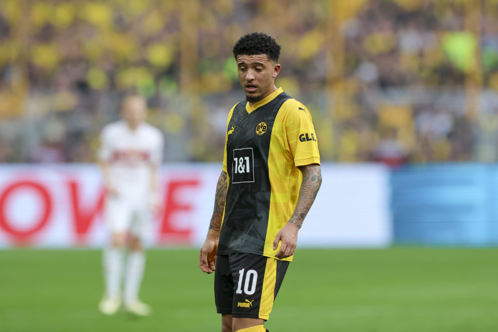 Jadon Sancho looks dejected in black and yellow Borussia Dortmund kit