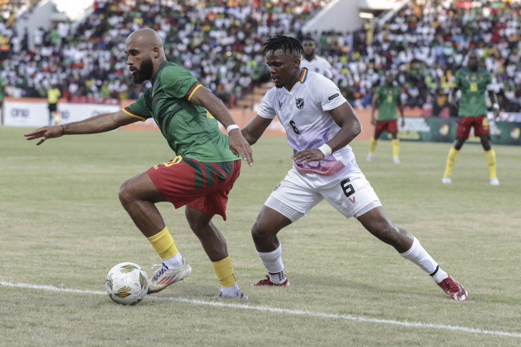 Bryan Mbeumo dribbles the ball for Cameroon, under pressure from opponent