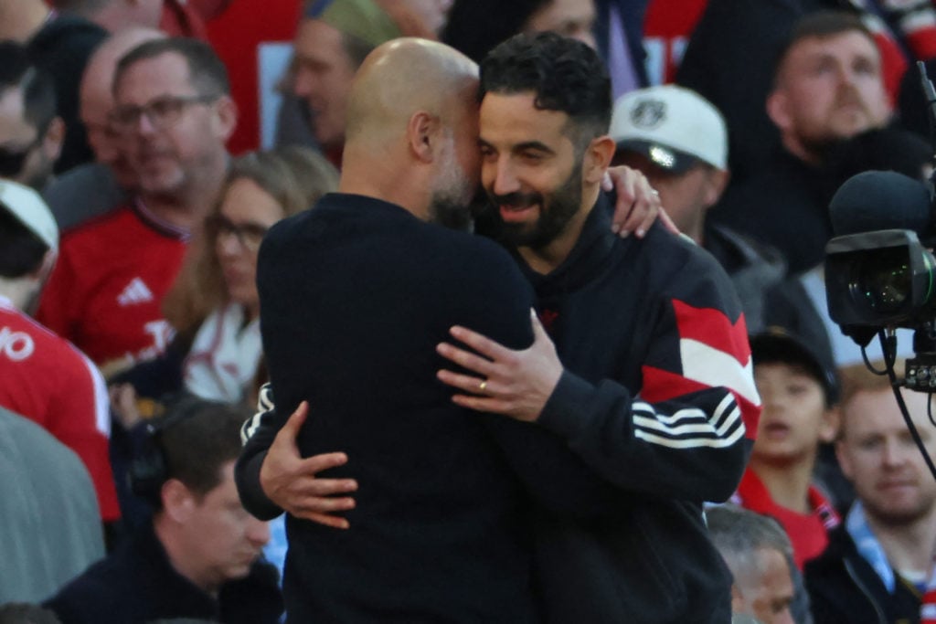 Manchester City manager Pep Guardiola and Manchester United head coach Ruben Amorim embrace on the final whistle in the Premier League match between Manchester United and Manchester City at Old Trafford in Manchester, England, in 2025.