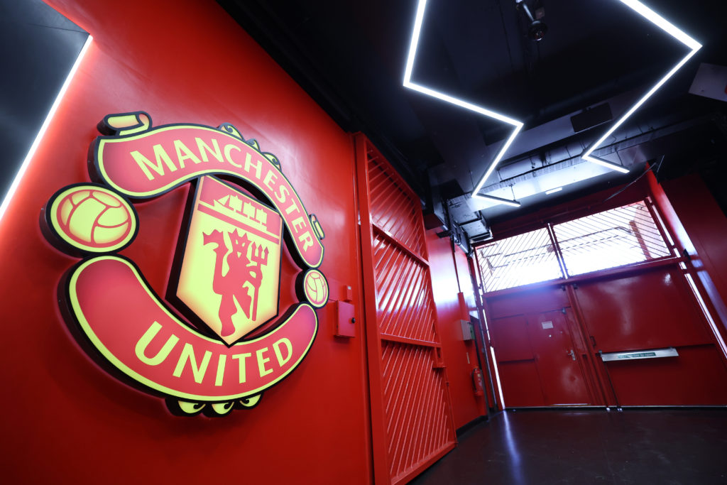A closeup shot of the Manchester United badge in a hallway at Old Trafford