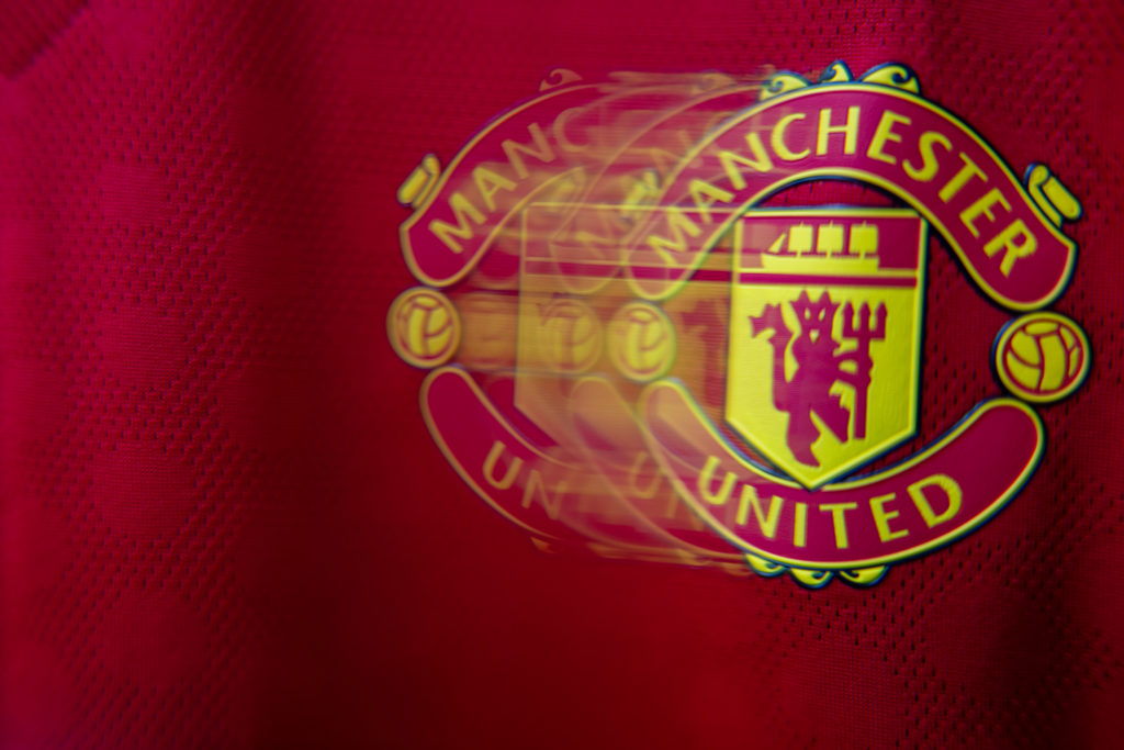 A closeup shot of the Manchester United badge on the club's home shirt