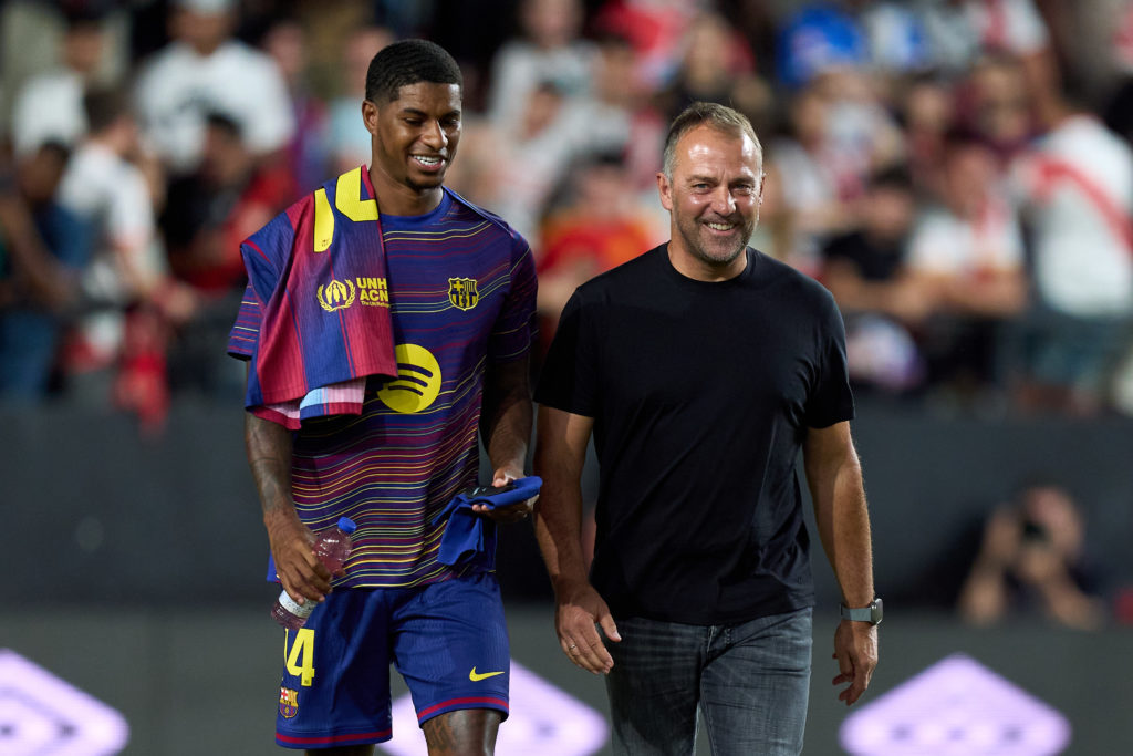 Manchester United and England player Marcus Rashford interacts with Barcelona manager Hansi Flick ahead of the La Liga match between Rayo Vallecano and Barcelona at the Estadio de Vallecas in 2025 in Madrid, Spain.