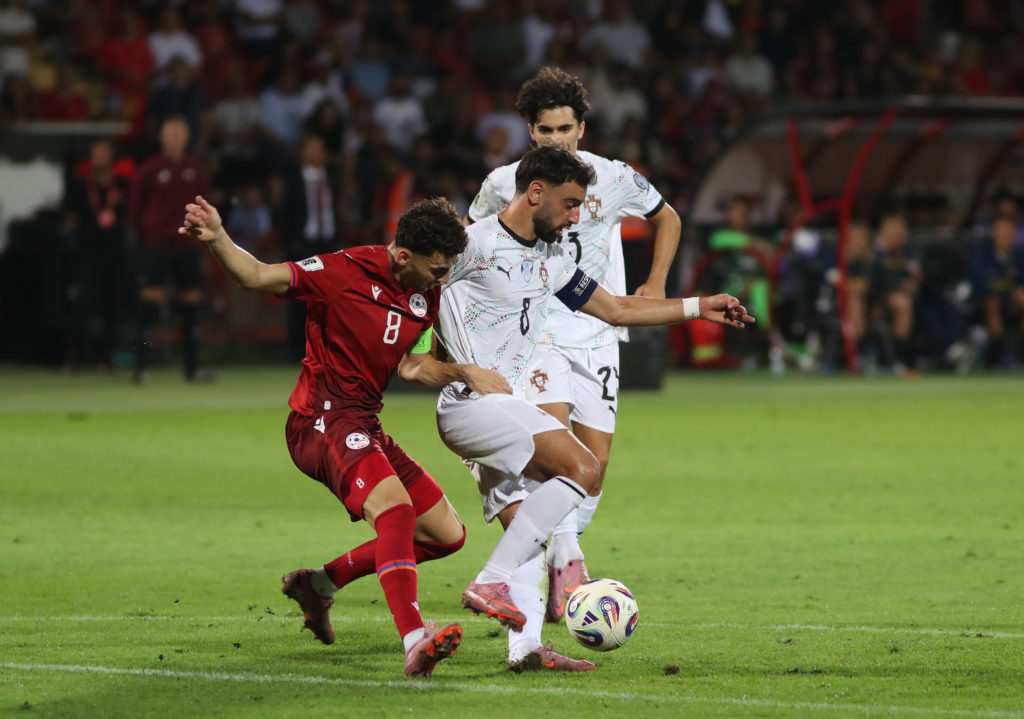 Eduard Spertsyan and Manchester United captain Bruno Fernandes battle for the ball during the World Cup 2026 qualifier match between Armenia and Portugal at the Vazgen Sargsyan Republican Stadium in 2025 in Yerevan, Armenia.