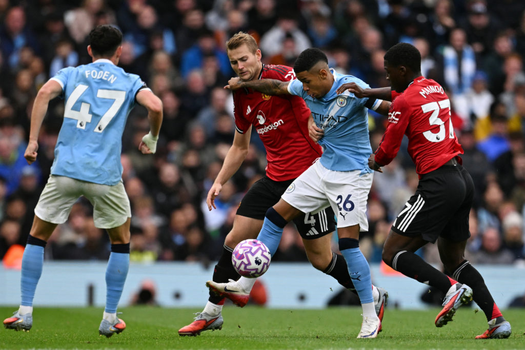 Manchester City's Brazilian midfielder #26 Savinho (2R) battles with Manchester United's English midfielder #37 Kobbie Mainoo (R)