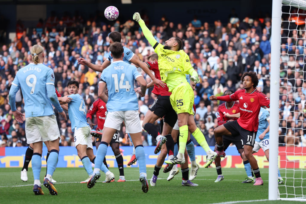 Gianluigi Donnarumma punches the ball out from a corner for City vs United