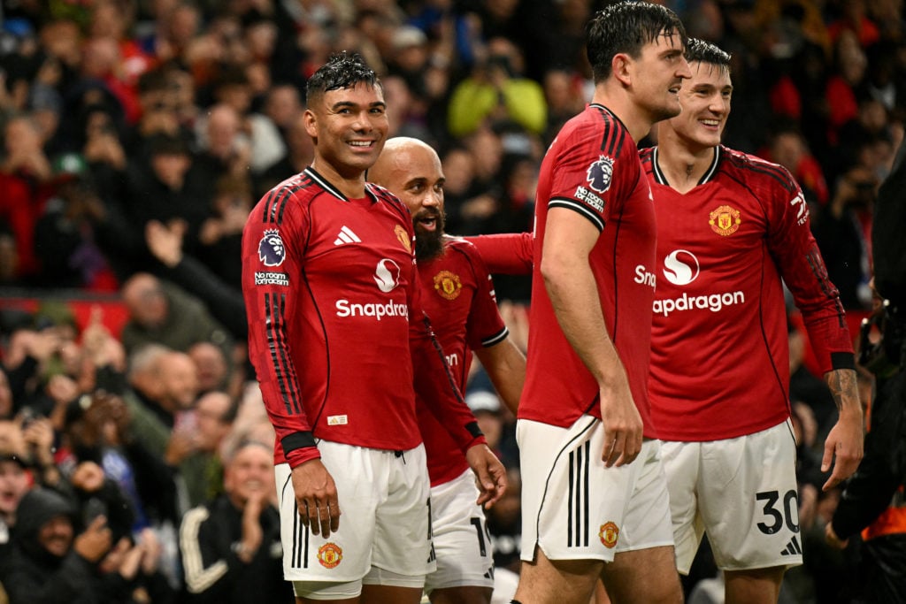 Manchester United's Brazilian midfielder #18 Casemiro (R) celebrates scoring the team's second goal during the English Premier League football match between Manchester United and Chelsea at Old Trafford in Manchester, north west England, on September 20, 2025