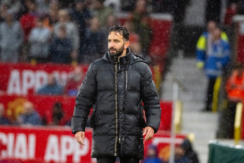 Ruben Amorim in the rain coaching Manchester United at Old Trafford.