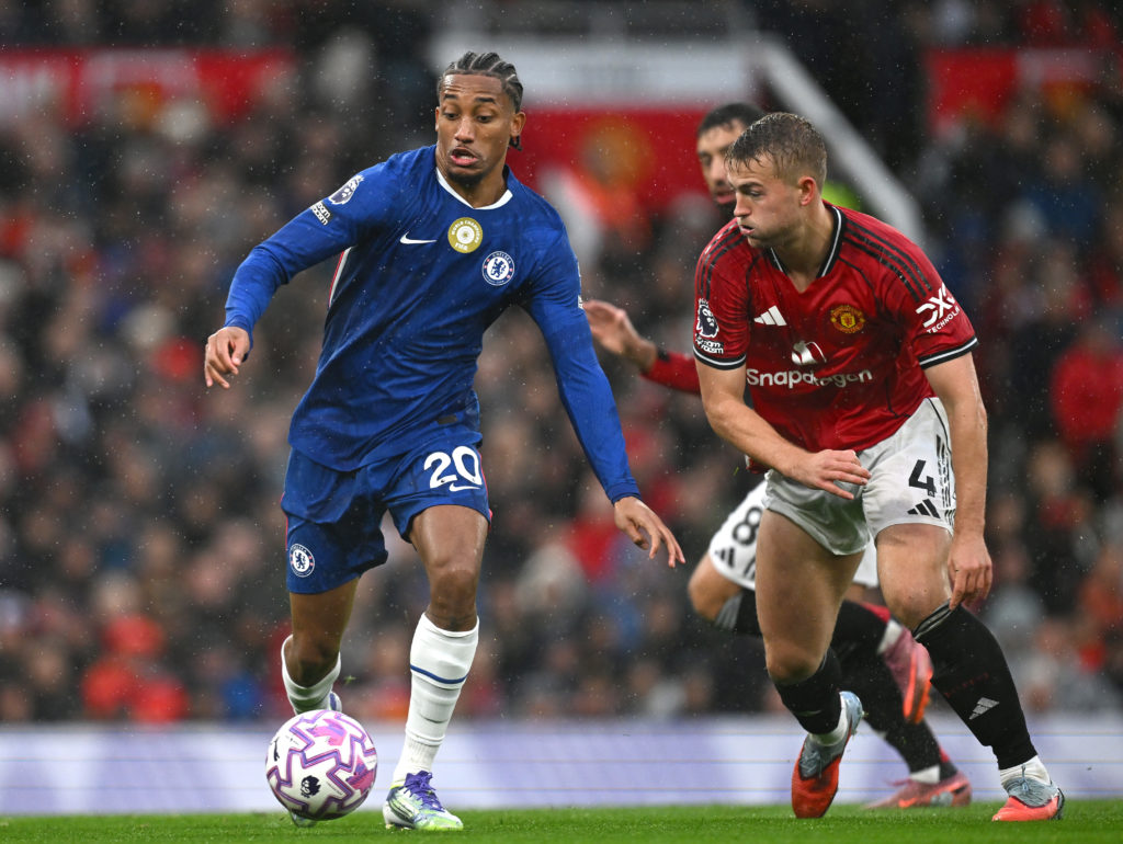 Joao Pedro runs with the ball while under pressure from Matthijs de Ligt during the Premier League match between Manchester United and Chelsea at Old Trafford in 2025 in Manchester, England.
