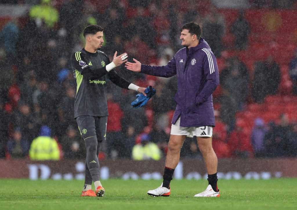 Altay Bayindir and Harry Maguire of Manchester United celebrate victory following the Premier League match between Manchester United and Chelsea at Old Trafford on September 20, 2025