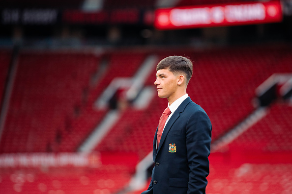 Shea Lacey at Old Trafford in Manchester United suit.