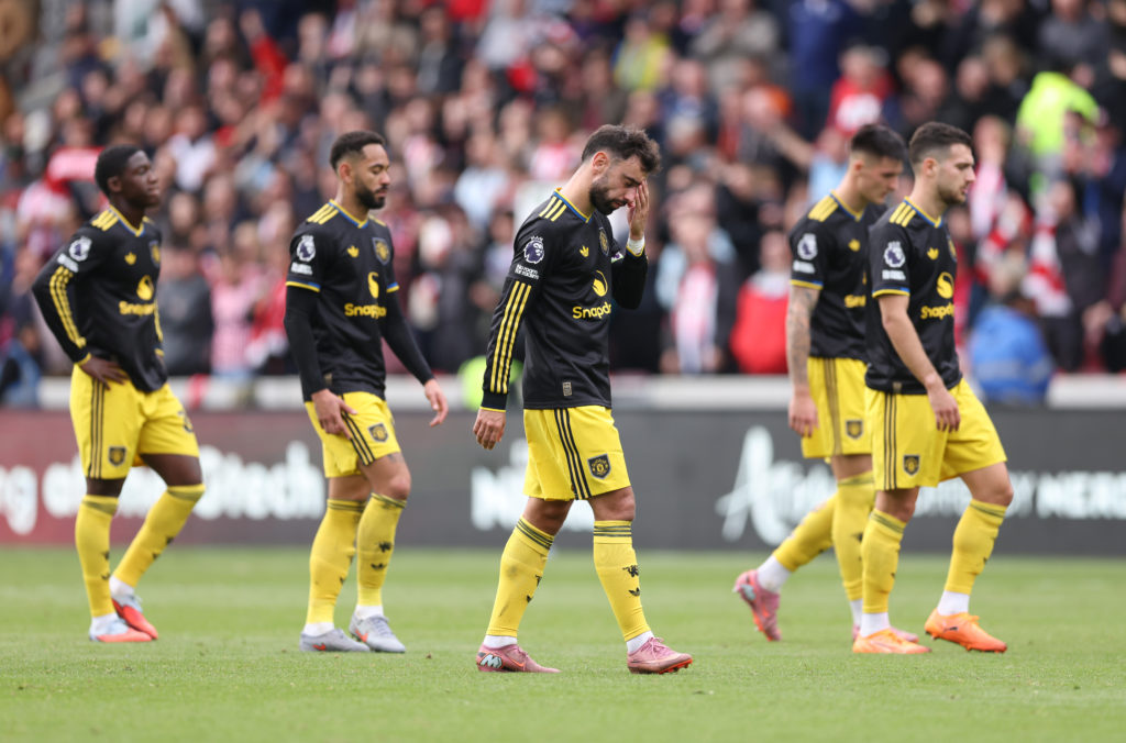 Manchester United players walk dejectedly after conceding to Brentford.