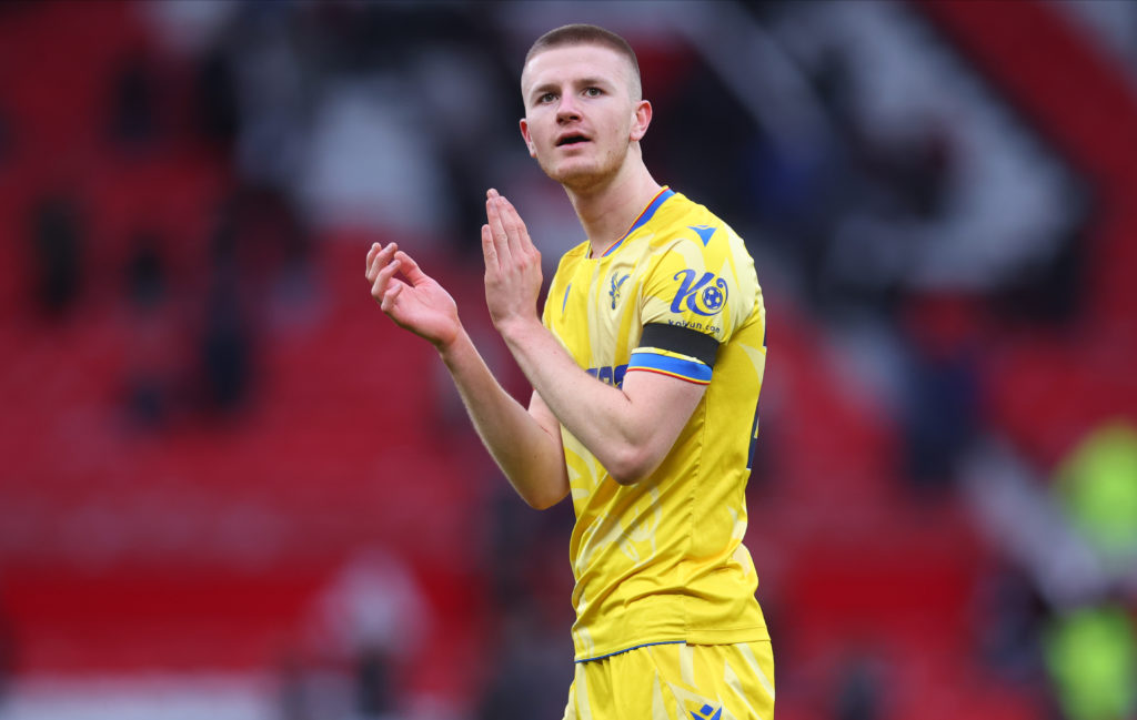Adam Wharton applauding Crystal Palace fans at Old Trafford