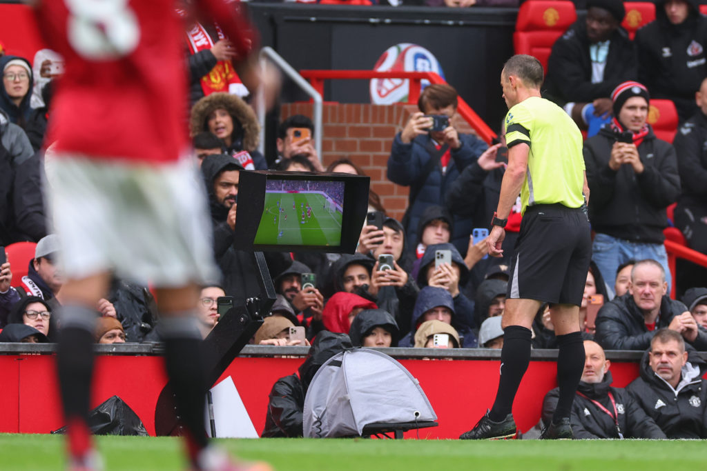Referee Stuart Attwell checks VAR monitor