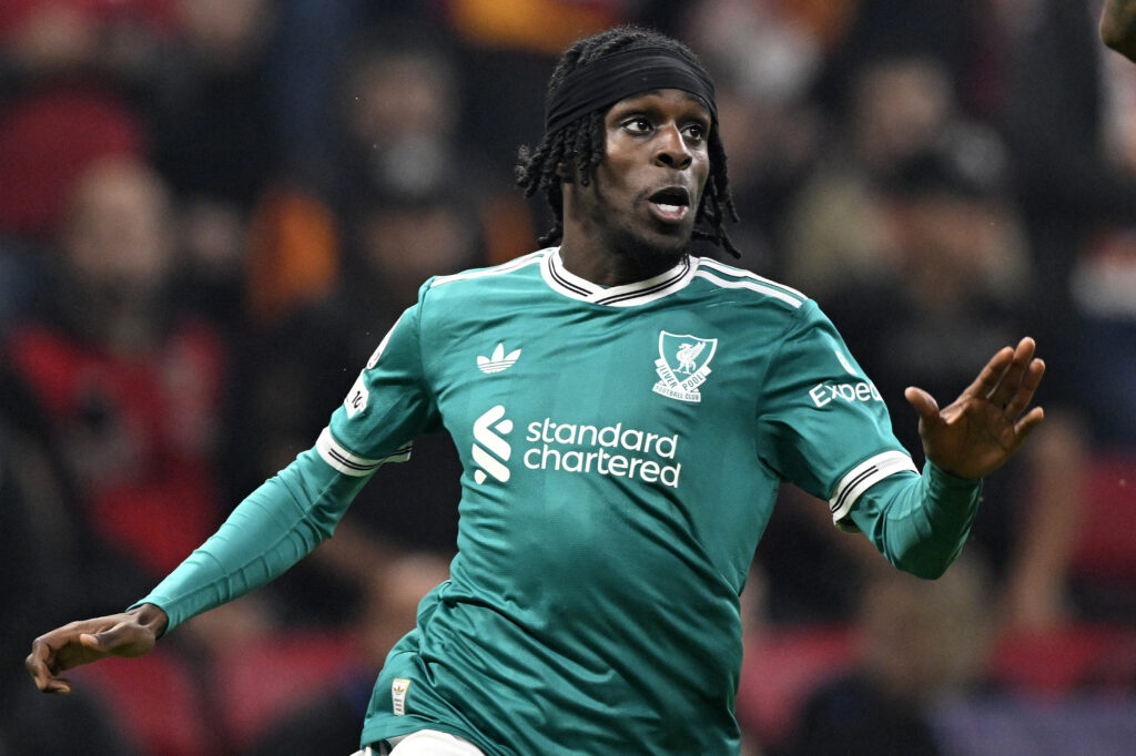 Jeremie Frimpong running in green Liverpool kit.