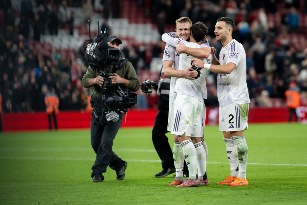 Matthijs de Ligt, Bruno Fernandes and Diogo Dalot celebrate at Anfield, with cameraman in shot