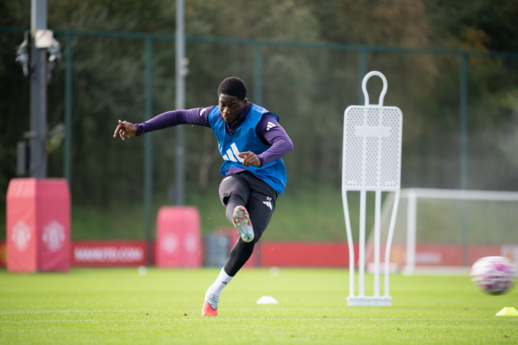 Kobbie Mainoo takes a shot in Manchester United Training Session