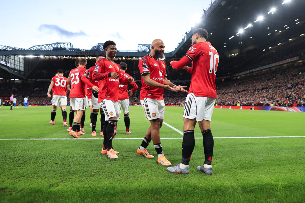 Matheus Cunha celebrates with Bryan Mbeumo after scoring during the Premier League match between Manchester United and Brighton and Hove Albion at Old Trafford in 2025 in Manchester, England.
