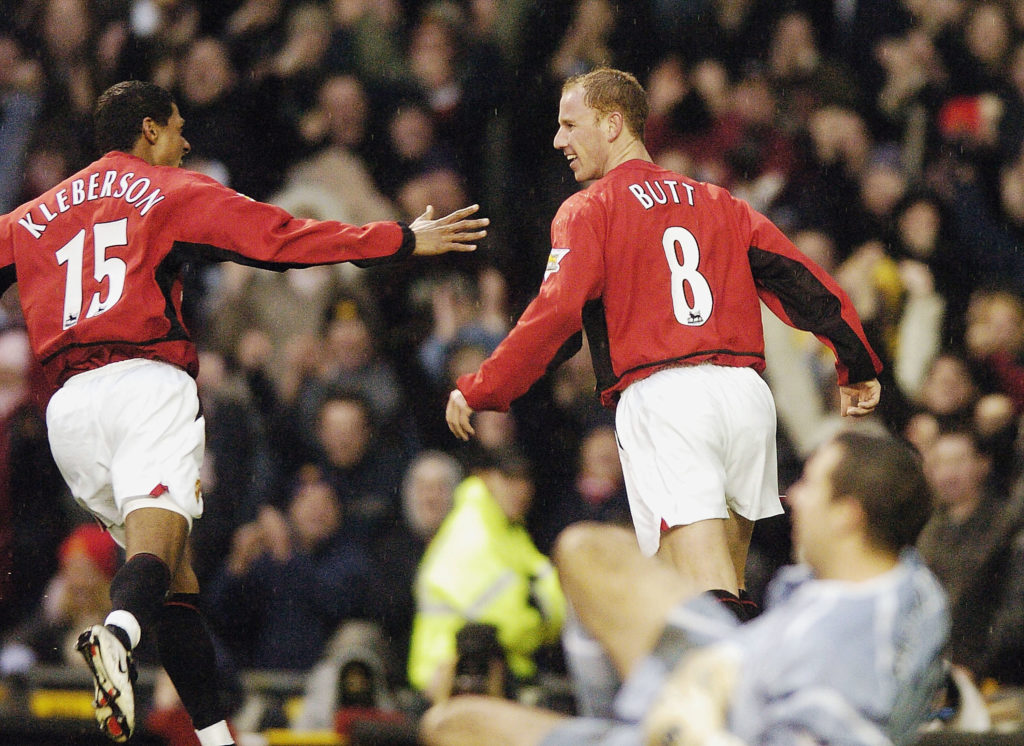 Nicky Butt celebrates scoring, with Kleberson chasing him