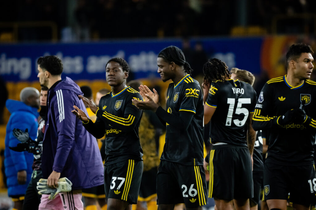 Kobbie Mainoo & Ayden Heaven of Manchester United applaud the fans at the end of the Premier League match between Wolverhampton Wanderers and Manchester United at Molineux on December 8, 2025