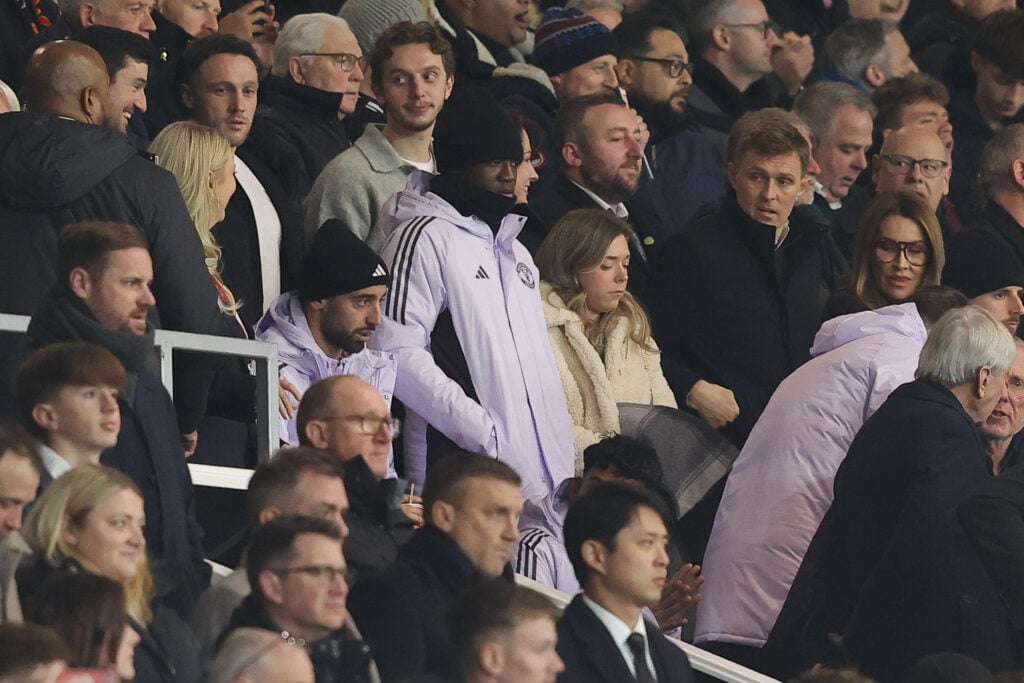 Bruno Fernandes and Kobbie Mainoo of Manchester United and former Manchester United player Darren Fletcher watch on during the Premier League match between Manchester United and Wolverhampton Wanderers at Old Trafford on December 30, 2025