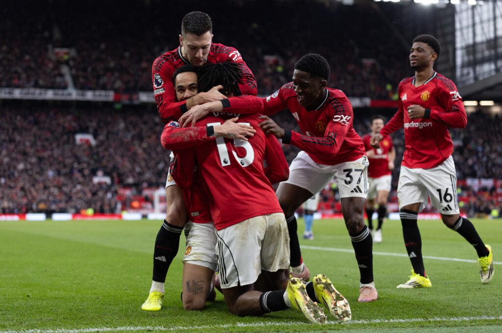 Manchester United players celebrating scoring in the Manchester derby at Old Trafford.