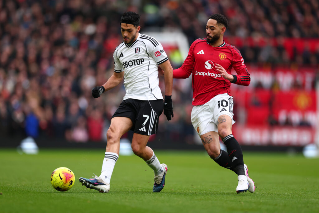 Raul Jimenez of Fulham is under pressure from Matheus Cunha
