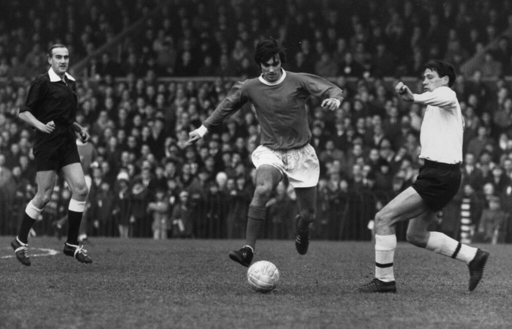 George Best runs with the ball for Manchester United