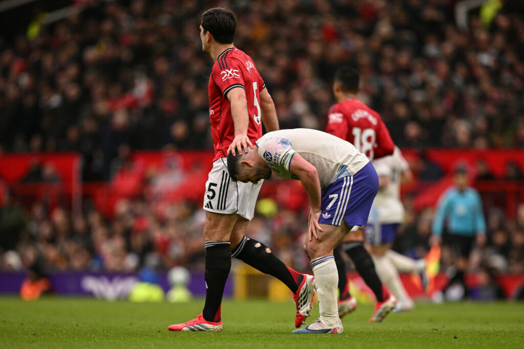 Manchester United's English defender #05 Harry Maguire (L) consoles Aston Villa's Scottish midfielder #07 John McGinn (R)