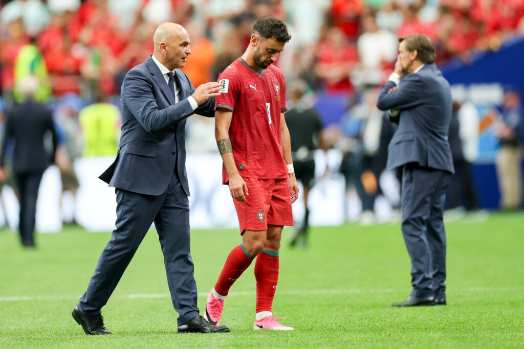 Roberto Martinez speaks to a disappointed Bruno Fernandes