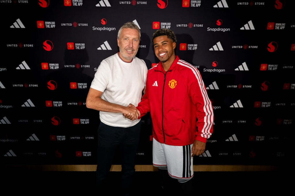 (EXCLUSIVE COVERAGE) Andrey Santos of Manchester United poses with Director of Football Jason Wilcox after signing for the club at Carrington Training Ground on July 13, 2026 in Manchester, England.
