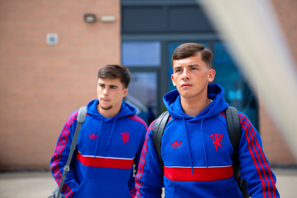Harry Amass, Shea Lacey of Manchester United checks in ahead of their flight to Trondheim at Manchester Airport on July 23, 2026 in Manchester, England.